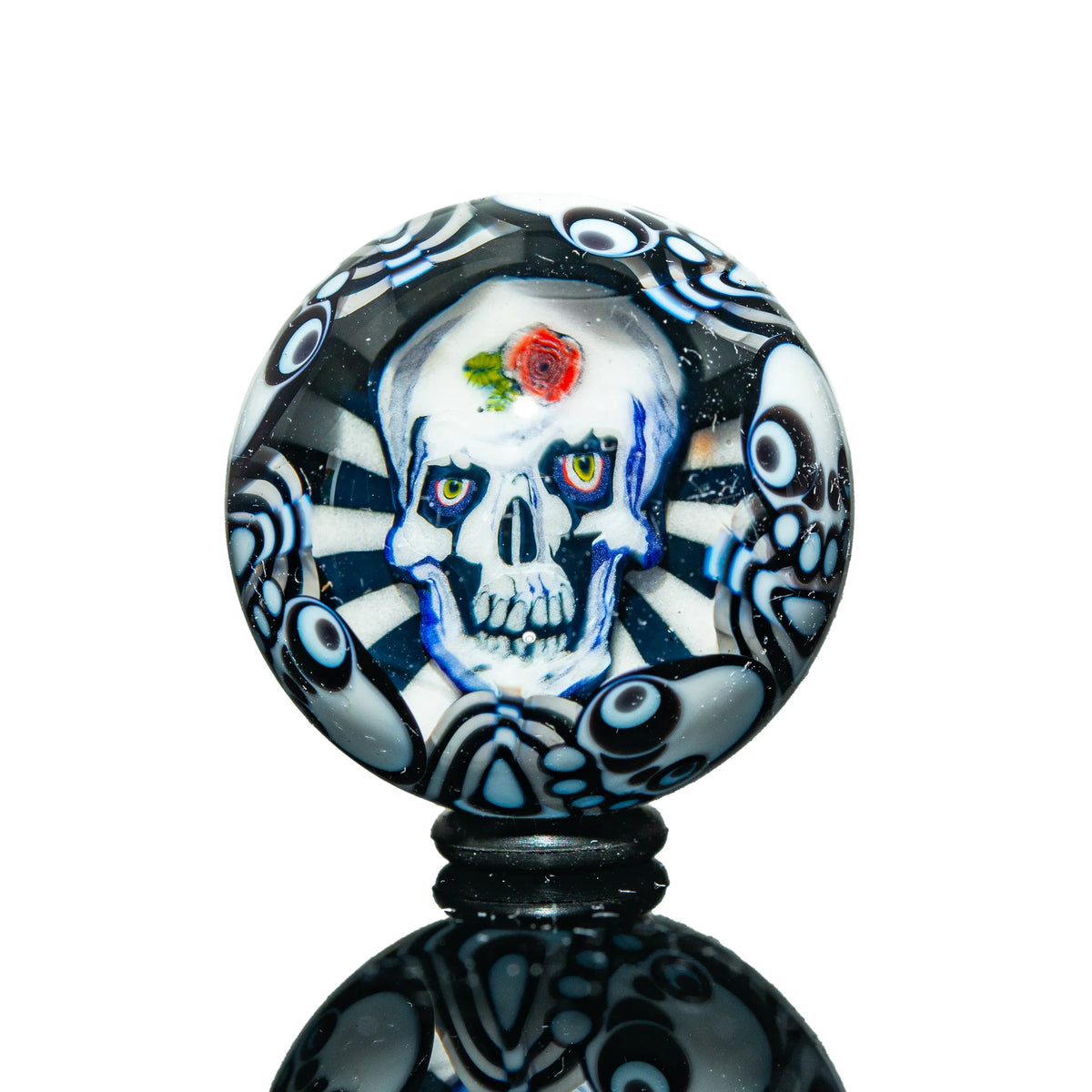 Handcrafted glass carb cap with skull and rose design, black and white psychedelic pattern
