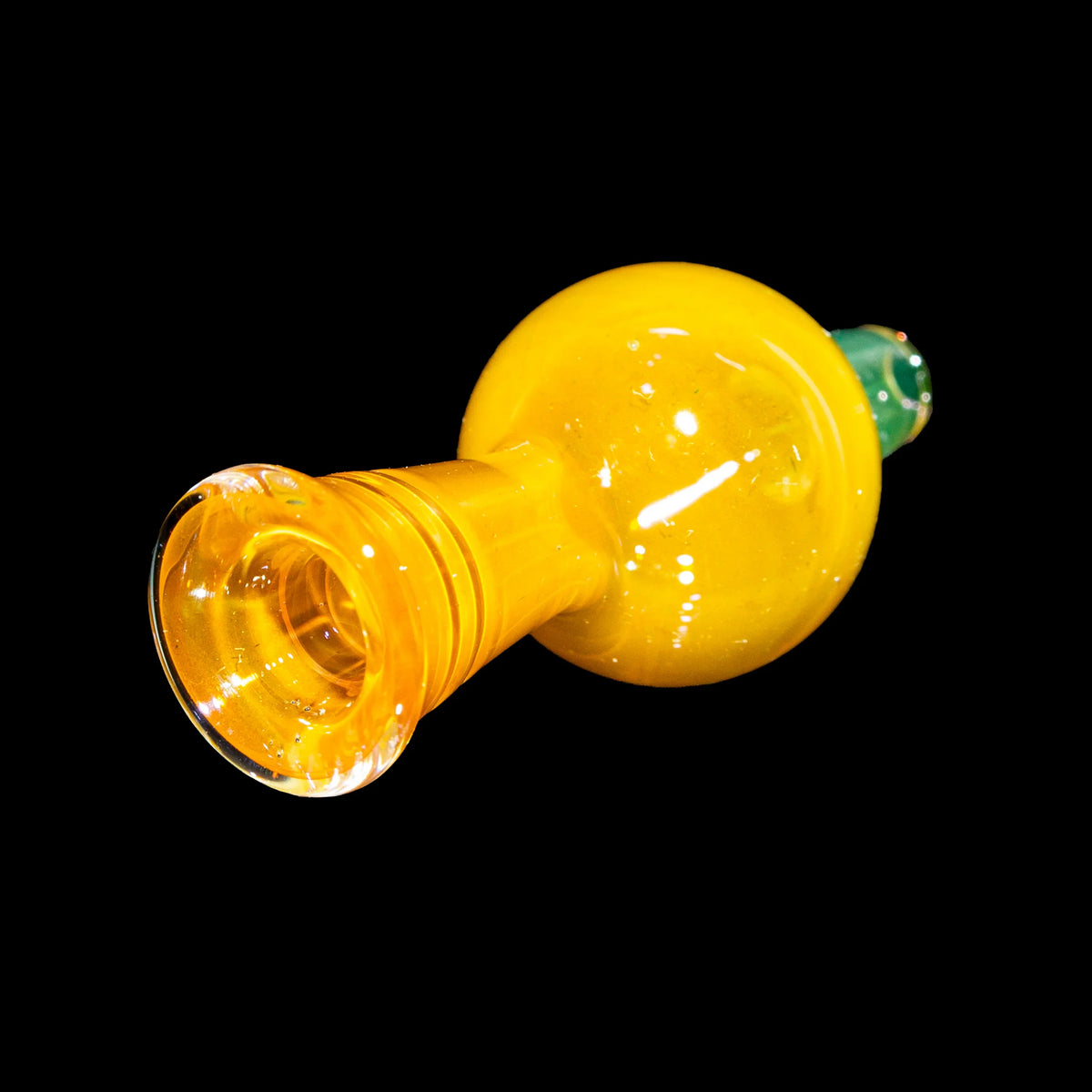 Yellow hand-blown glass pipe with green accent on black background