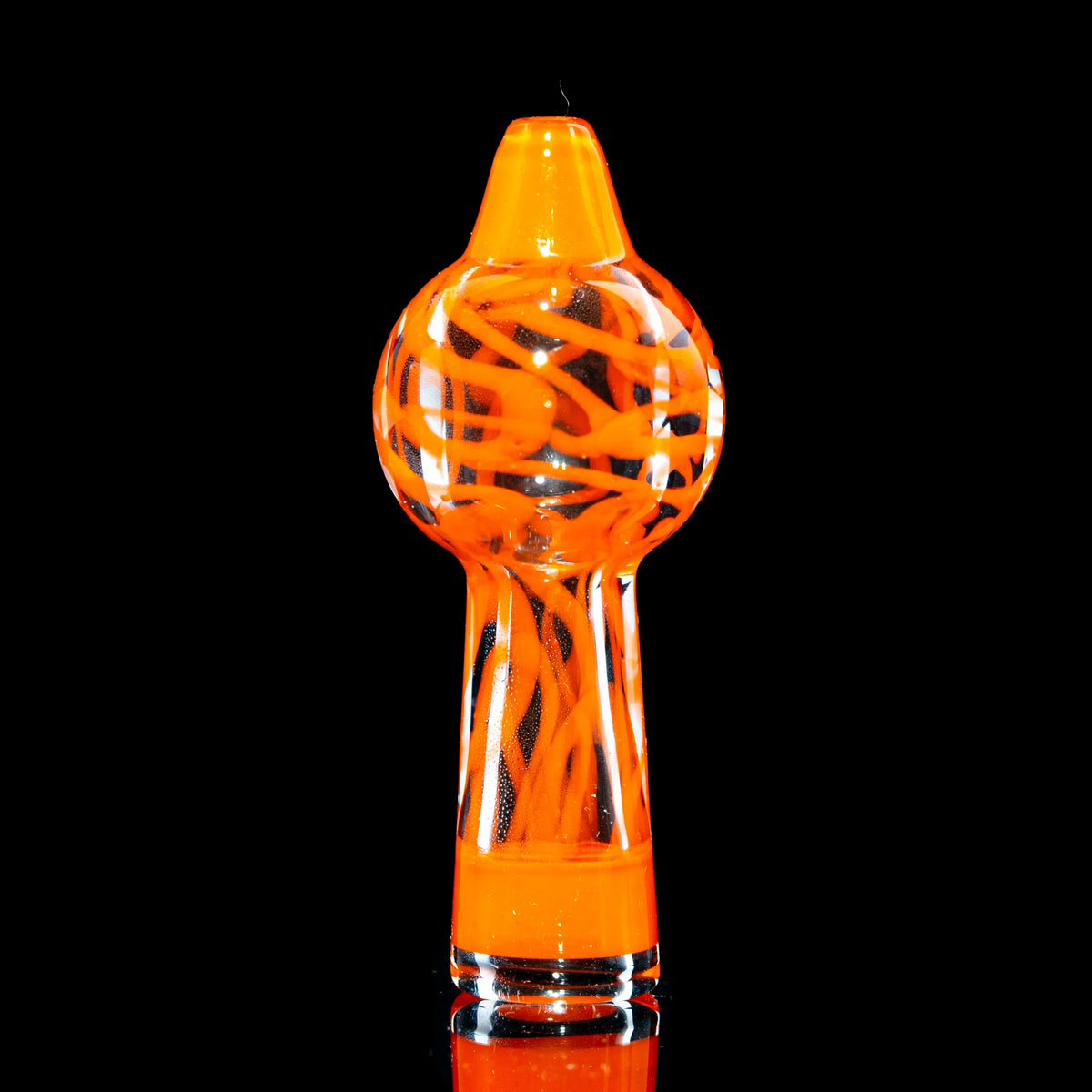 Orange glass carb cap with swirling design for dab rigs on black background