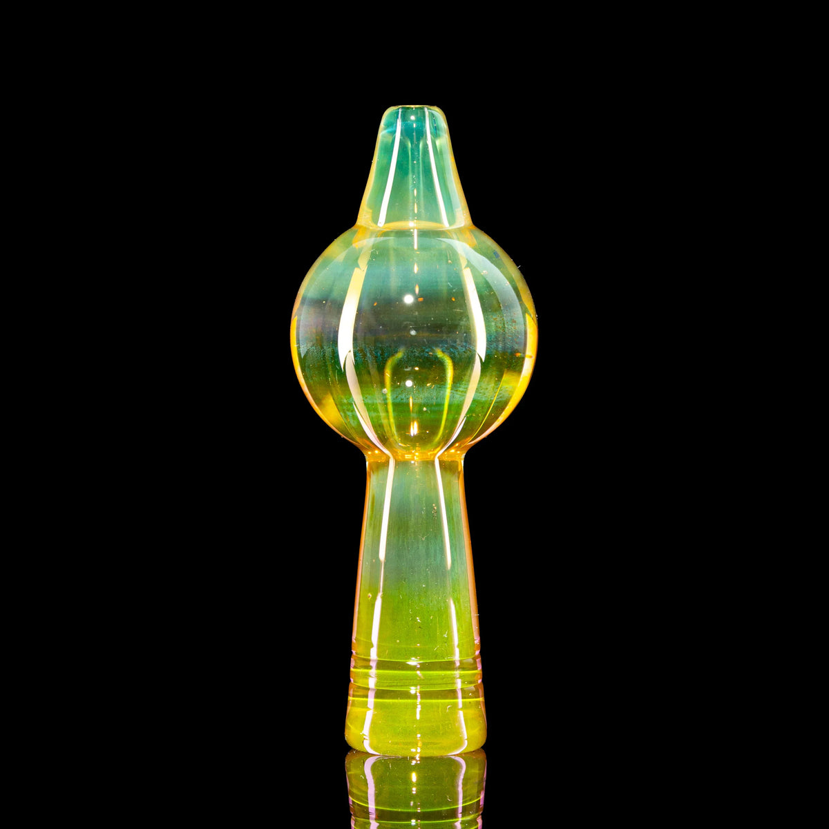Iridescent glass carb cap for dab rigs, yellow and green, on black background