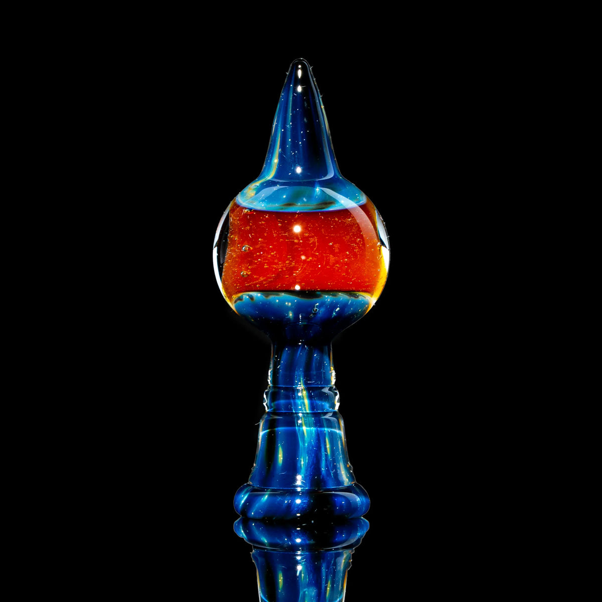 Handcrafted blue and orange glass dabber tool with cosmic design on black background