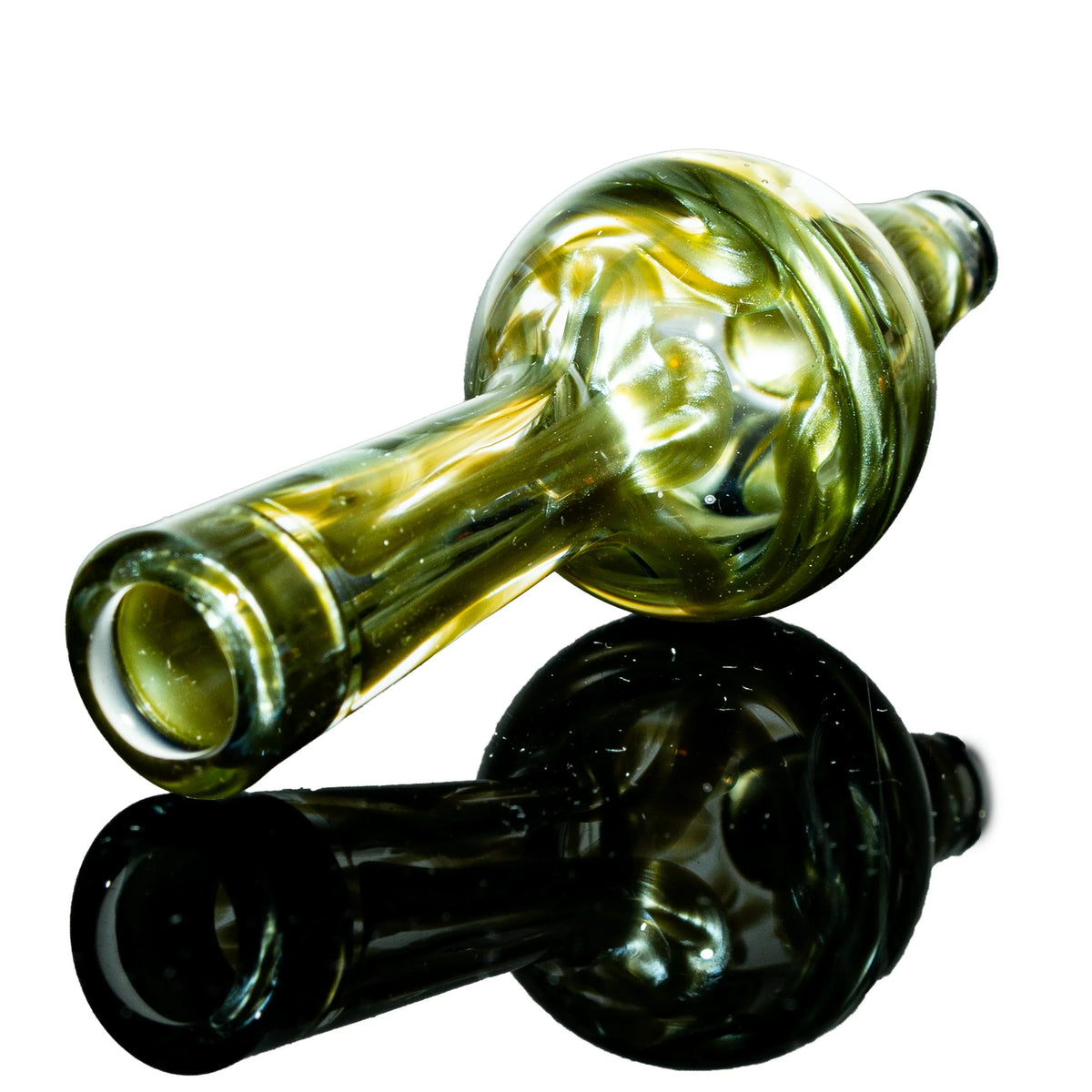 Hand-blown glass pipe with green and gold swirls on white reflective background