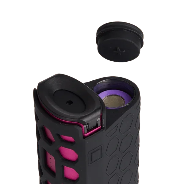 Close-up of a portable vaporizer device with hexagonal grip and removable battery cap