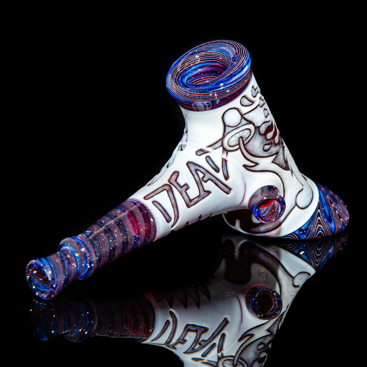 Heady glass hand pipe with intricate swirls, purple and blue accents, and reflective black background.