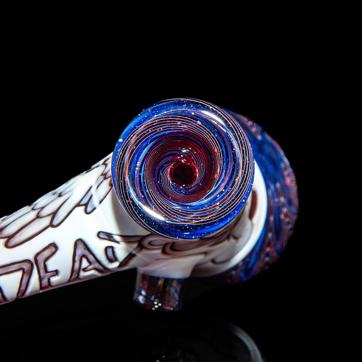 Glass hand pipe with blue, red, and white spiral design on black background
