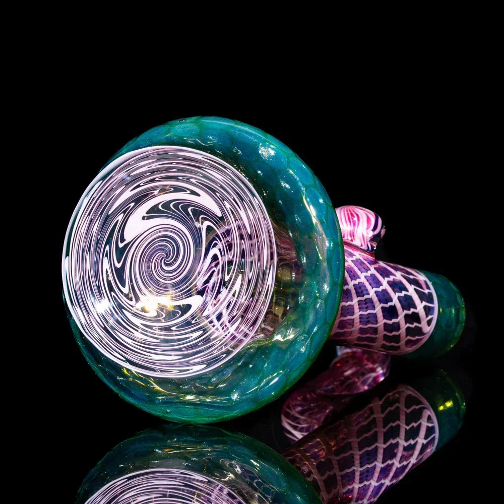 Intricate honeycomb glass bubbler with seashell pattern, vibrant colors on black background