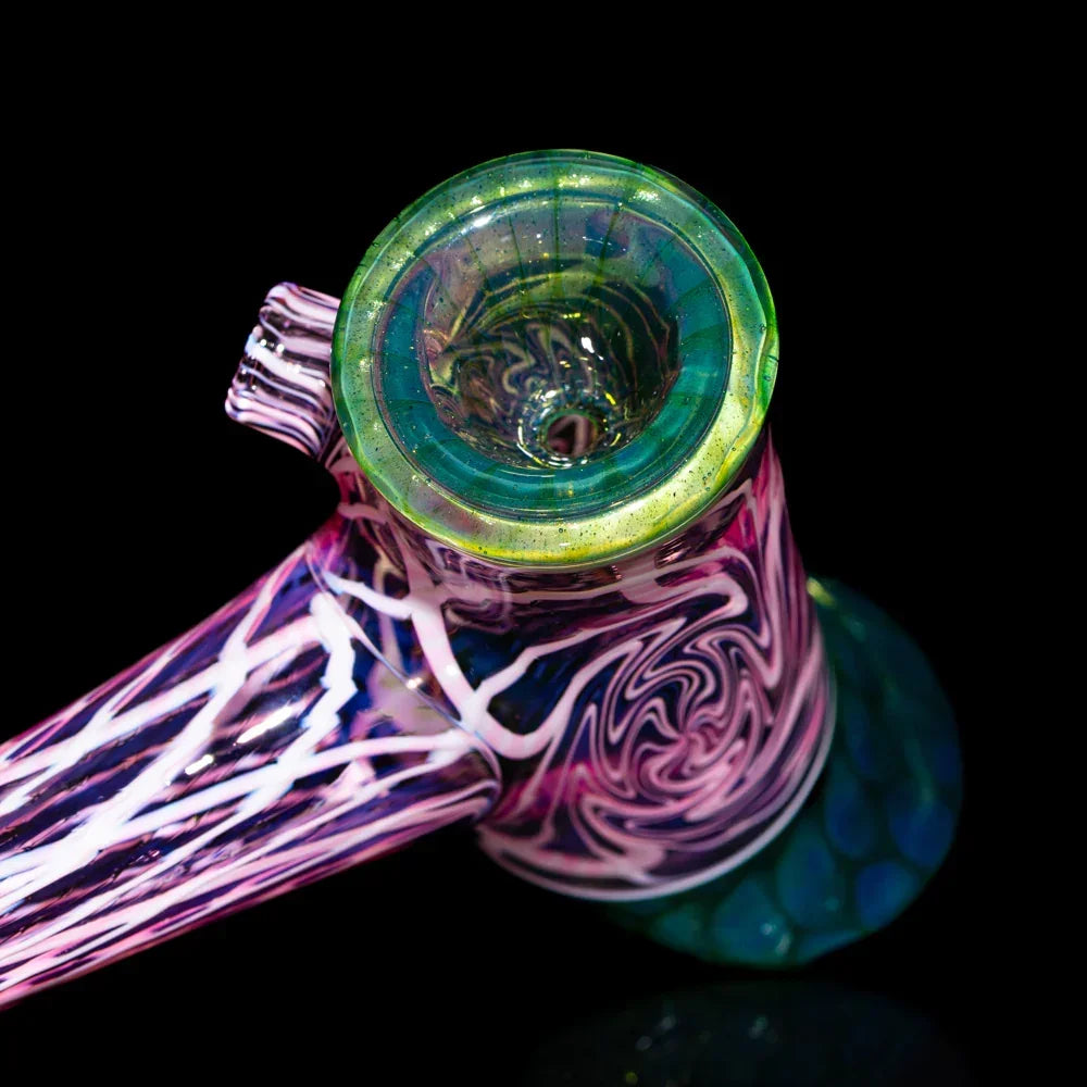 Colorful glass hand pipe with twisted seashell and honeycomb designs on black background