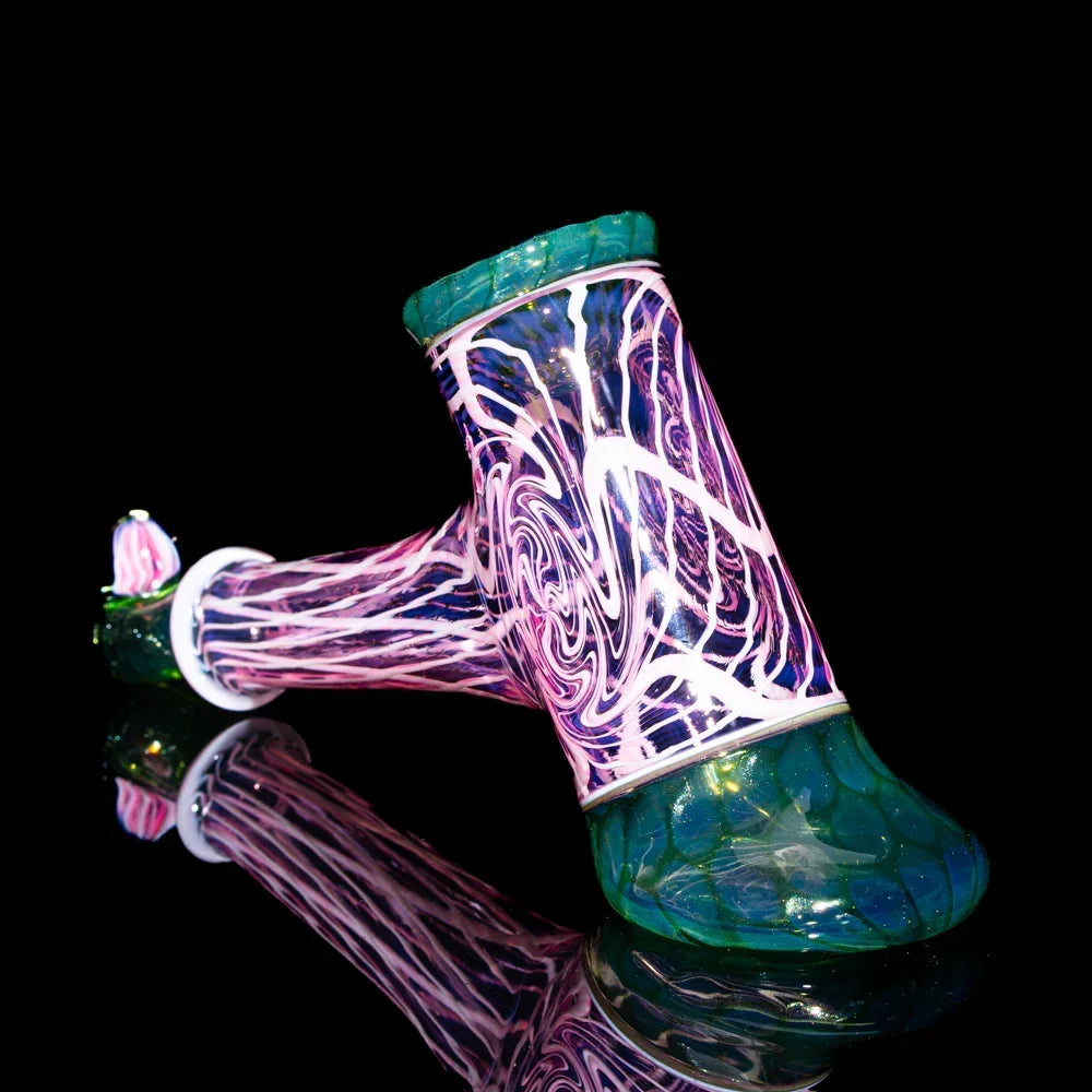 Colorful twisted glass hammer pipe with honeycomb and seashell patterns on black background.