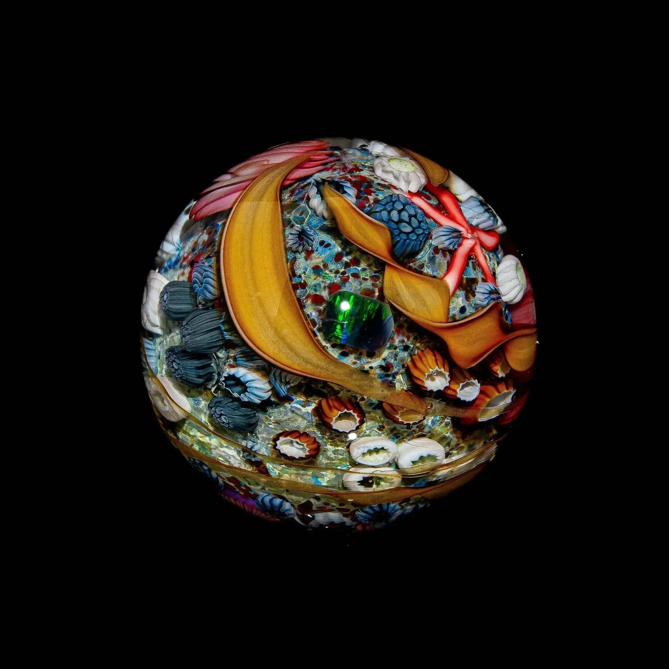 Intricate heady glass marble with colorful tide pool ocean designs on a black background