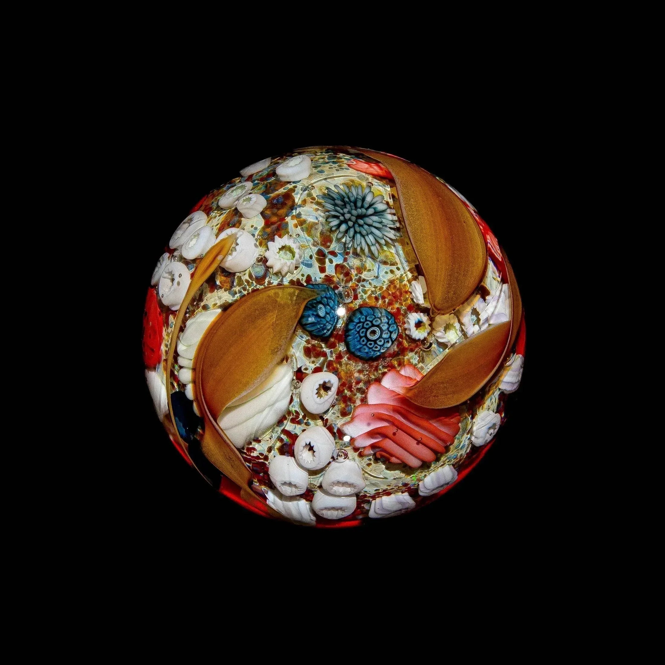Handcrafted glass marble featuring intricate ocean-inspired designs and vibrant colors