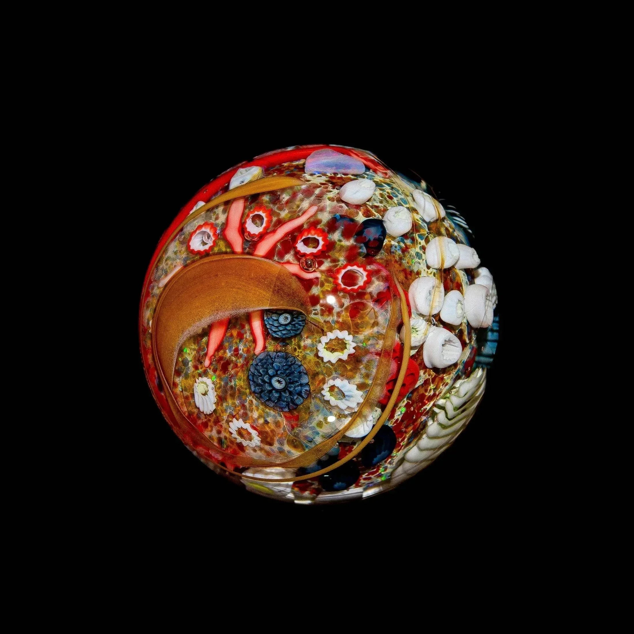 Handcrafted glass art marble with vibrant octopus and sea life design on black background