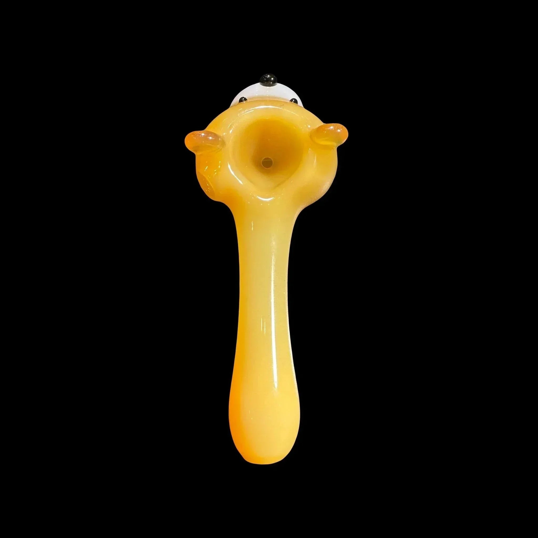 Yellow glass hand pipe shaped like a cartoon animal, on black background