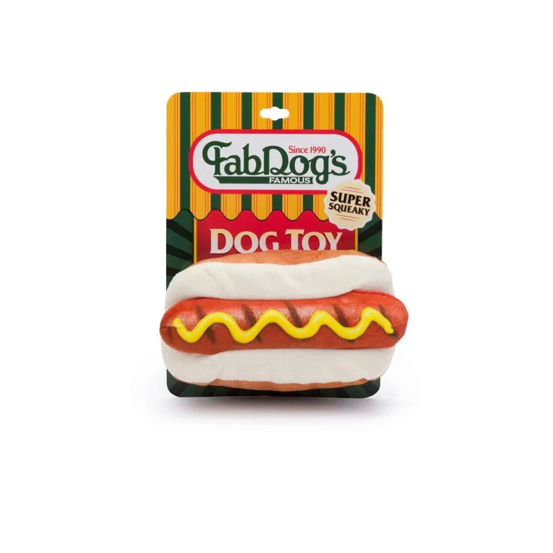 Hot dog shaped squeaky dog toy in packaging with yellow mustard design