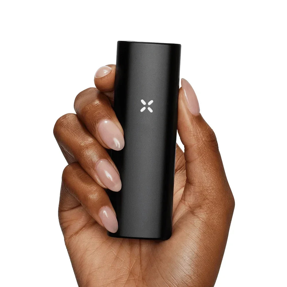 Hand holding a sleek black portable vaporizer with LED indicator on white background.