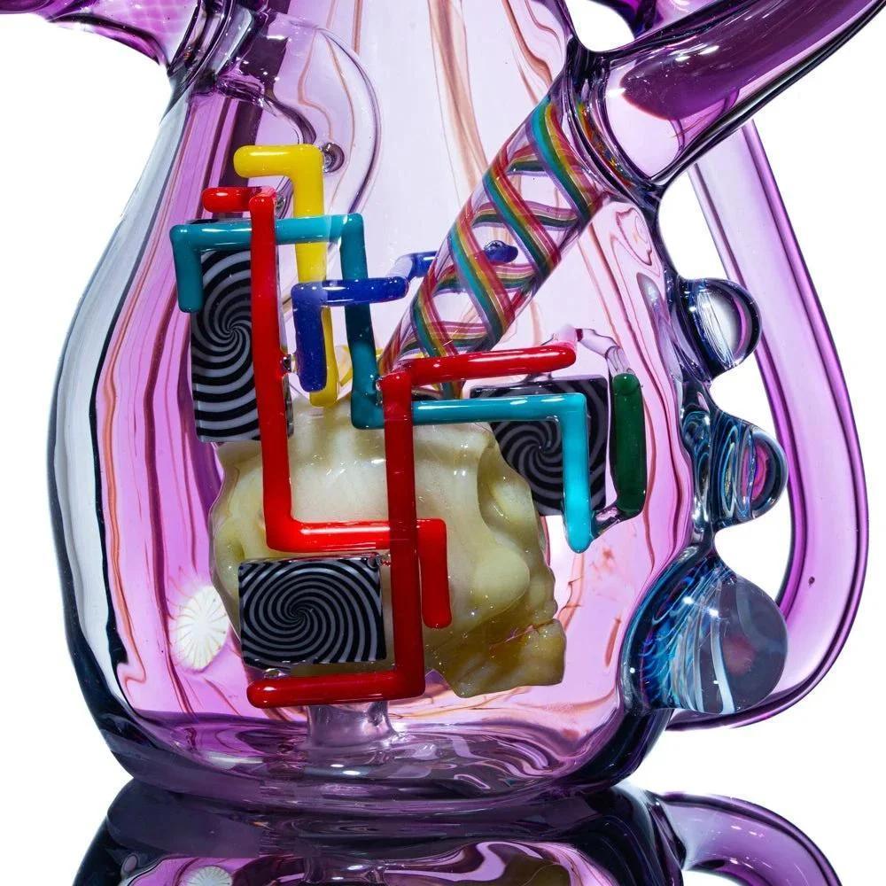 Close-up of intricate heady glass water pipe with colorful geometric accents and swirl patterns
