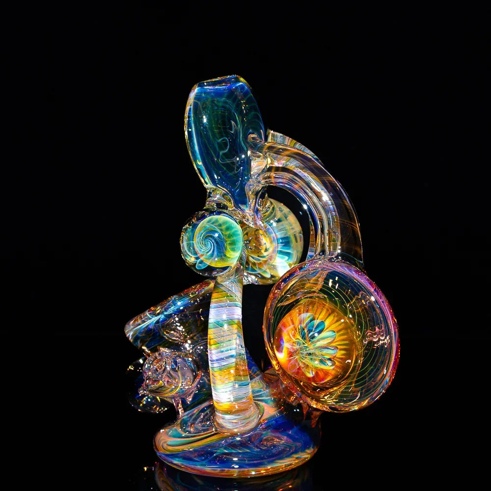 Heady glass water pipe with vibrant fume swirl designs against a black background.