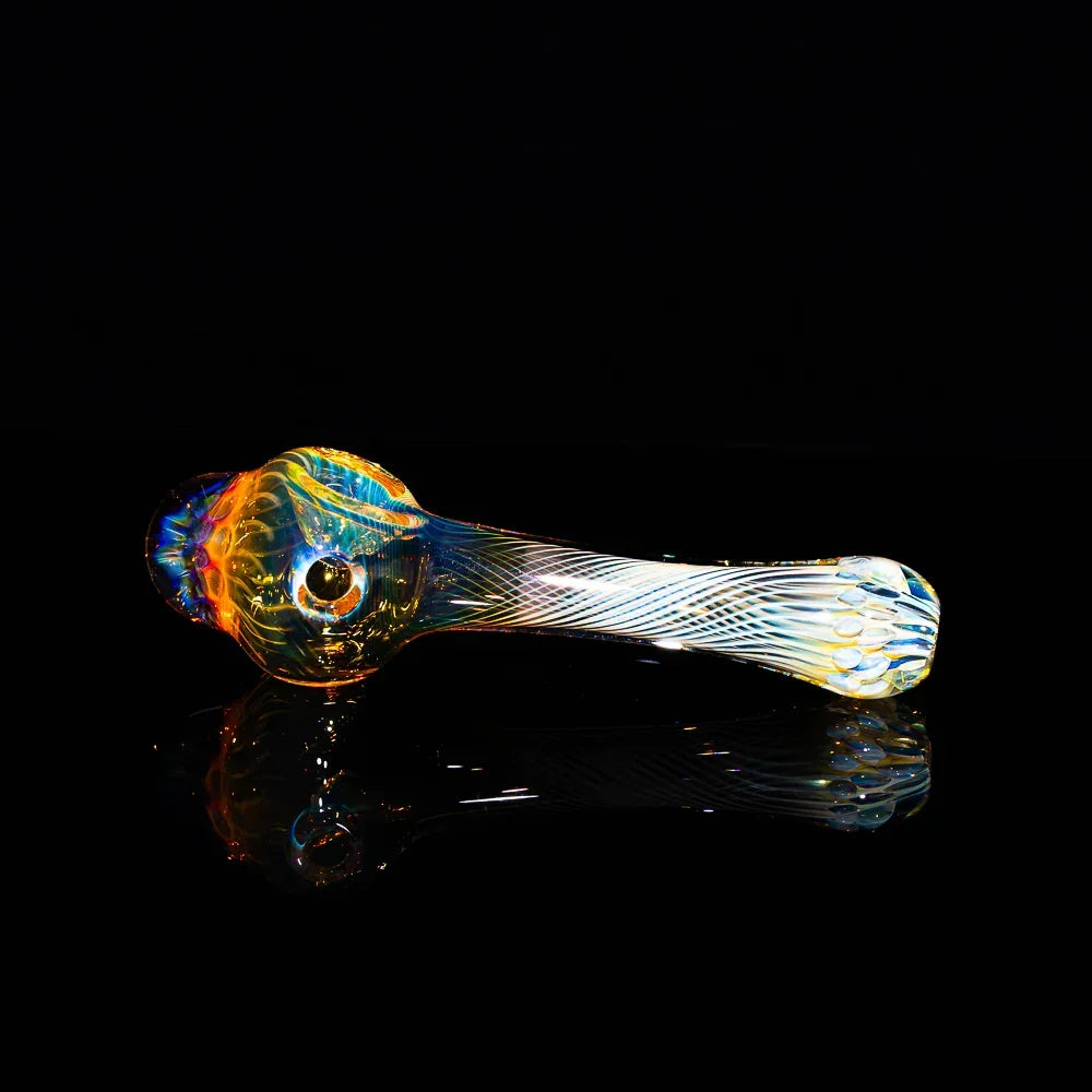 Honeycomb fume glass spoon pipe with colorful swirls on a black background