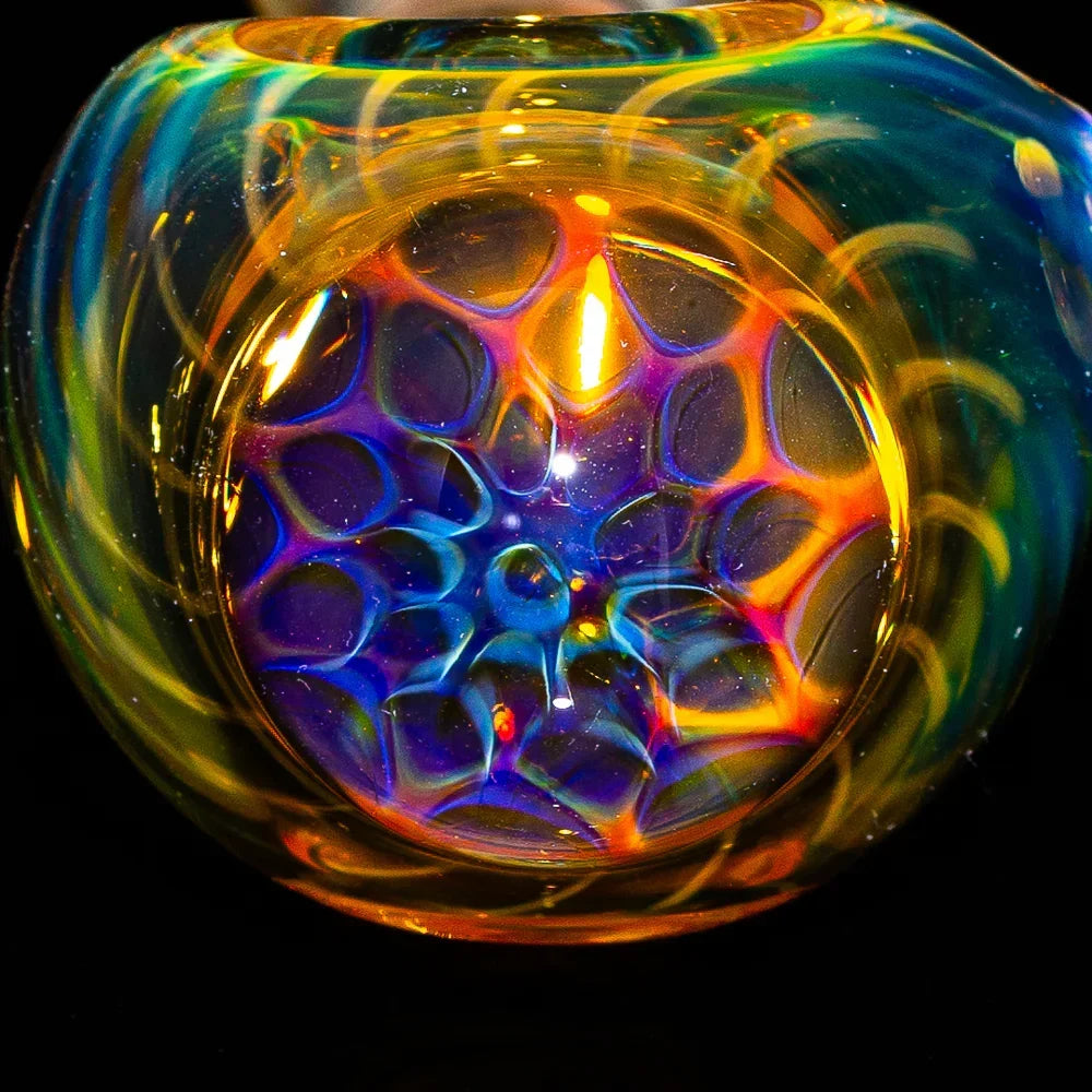 Colorful glass spoon pipe with a vibrant honeycomb pattern and fumed glass accents