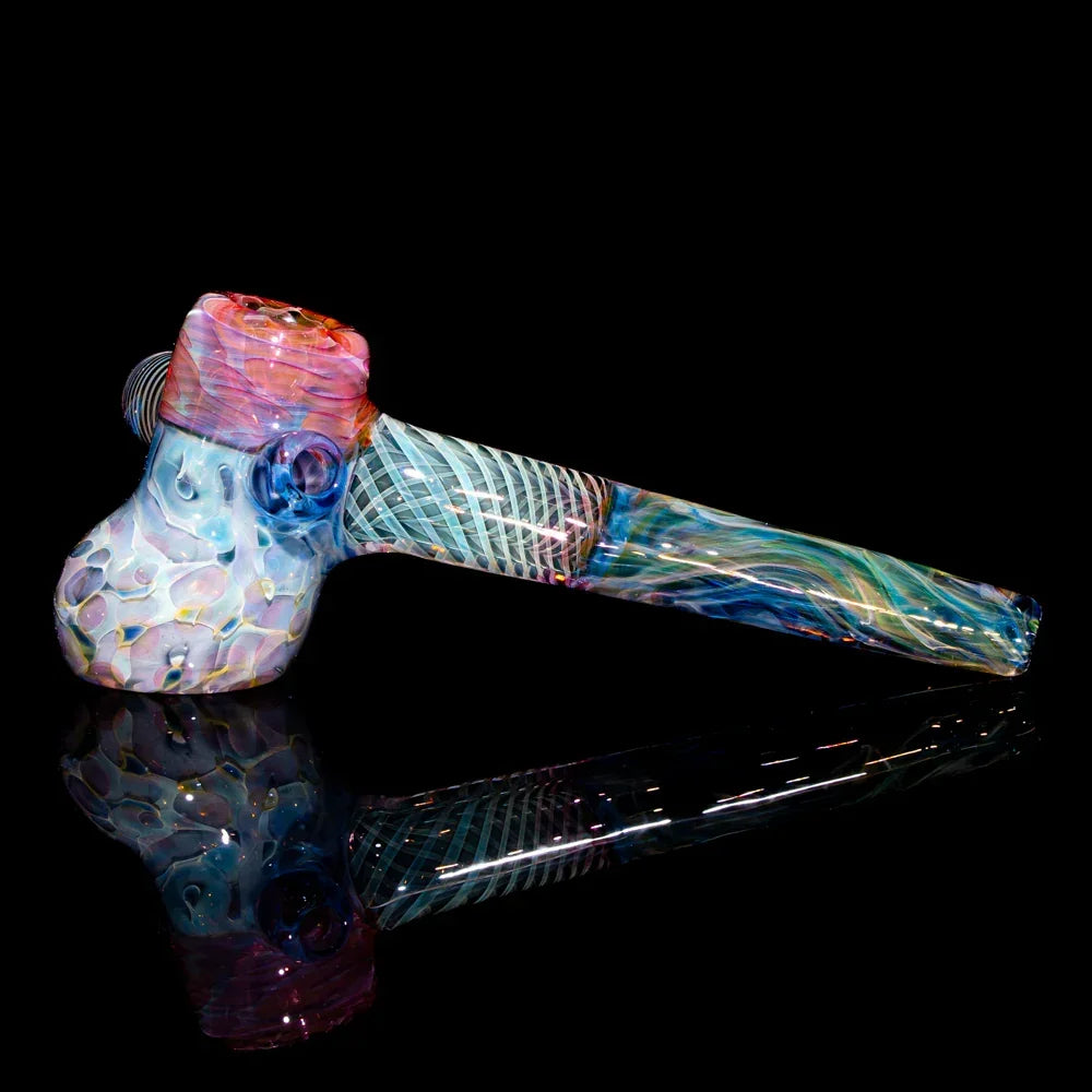 Colorful heady glass hammer pipe with intricate patterns on a black background