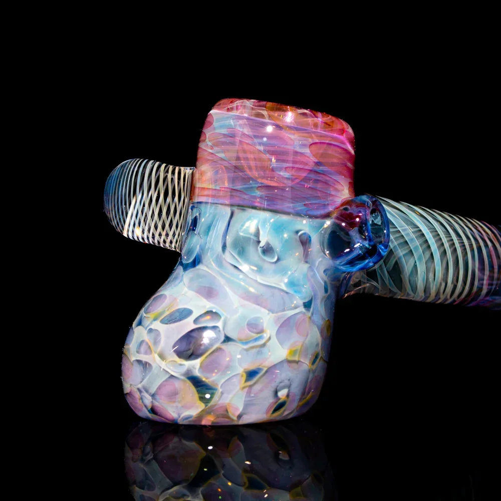 Heady glass hammer pipe with colorful swirling patterns and intricate designs on black background.