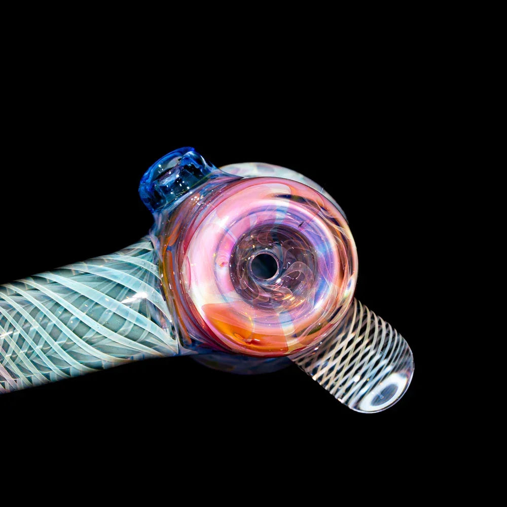 Colorful glass hand pipe with intricate patterns on a black background