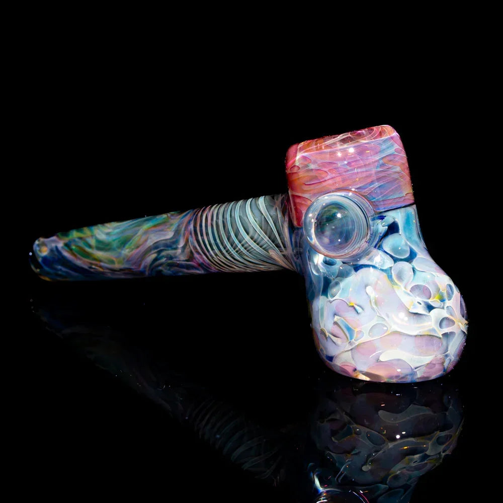 Colorful artistic glass hammer pipe with swirling patterns on black background