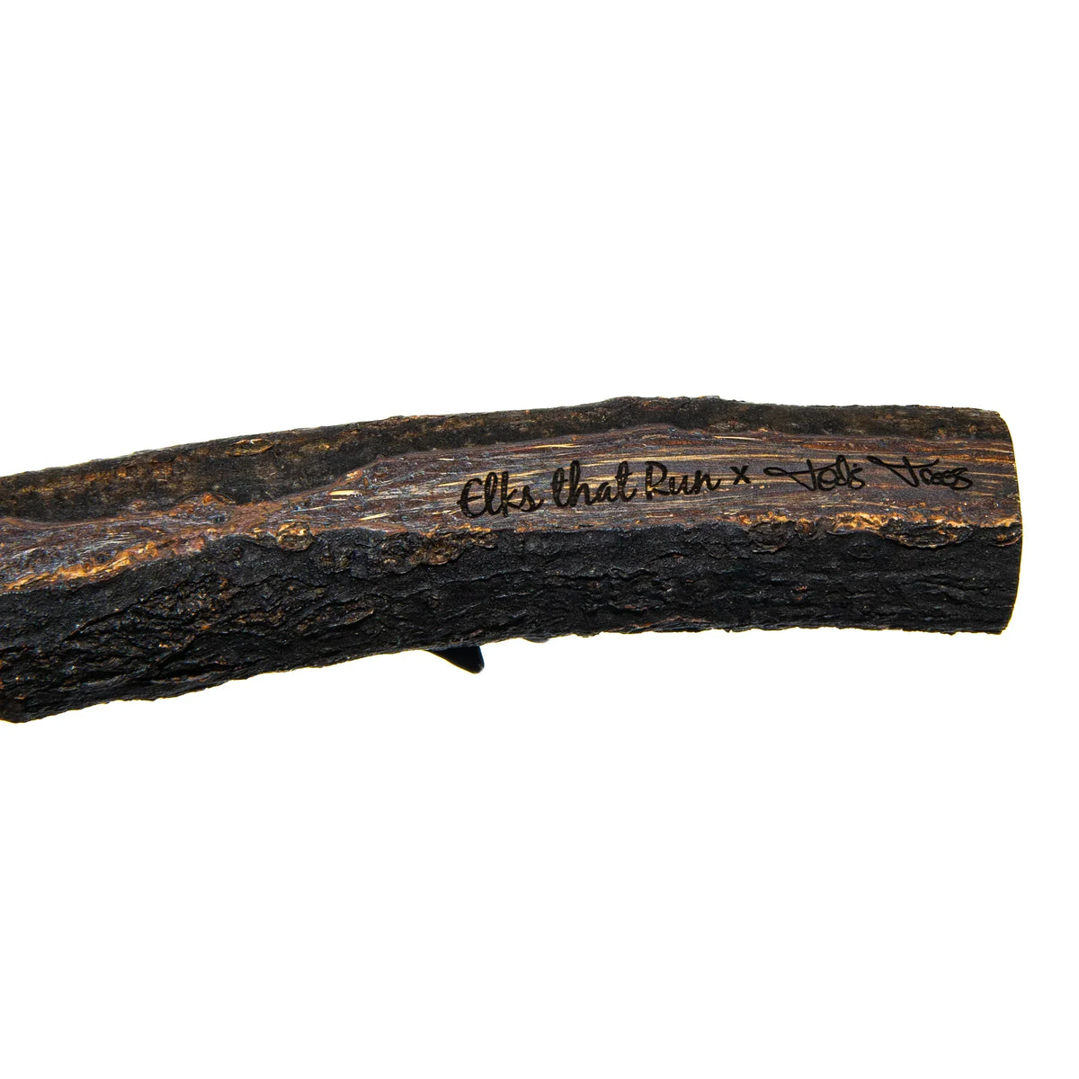 Handcrafted wooden pipe with bark texture and artist signature, glass gallery accessory