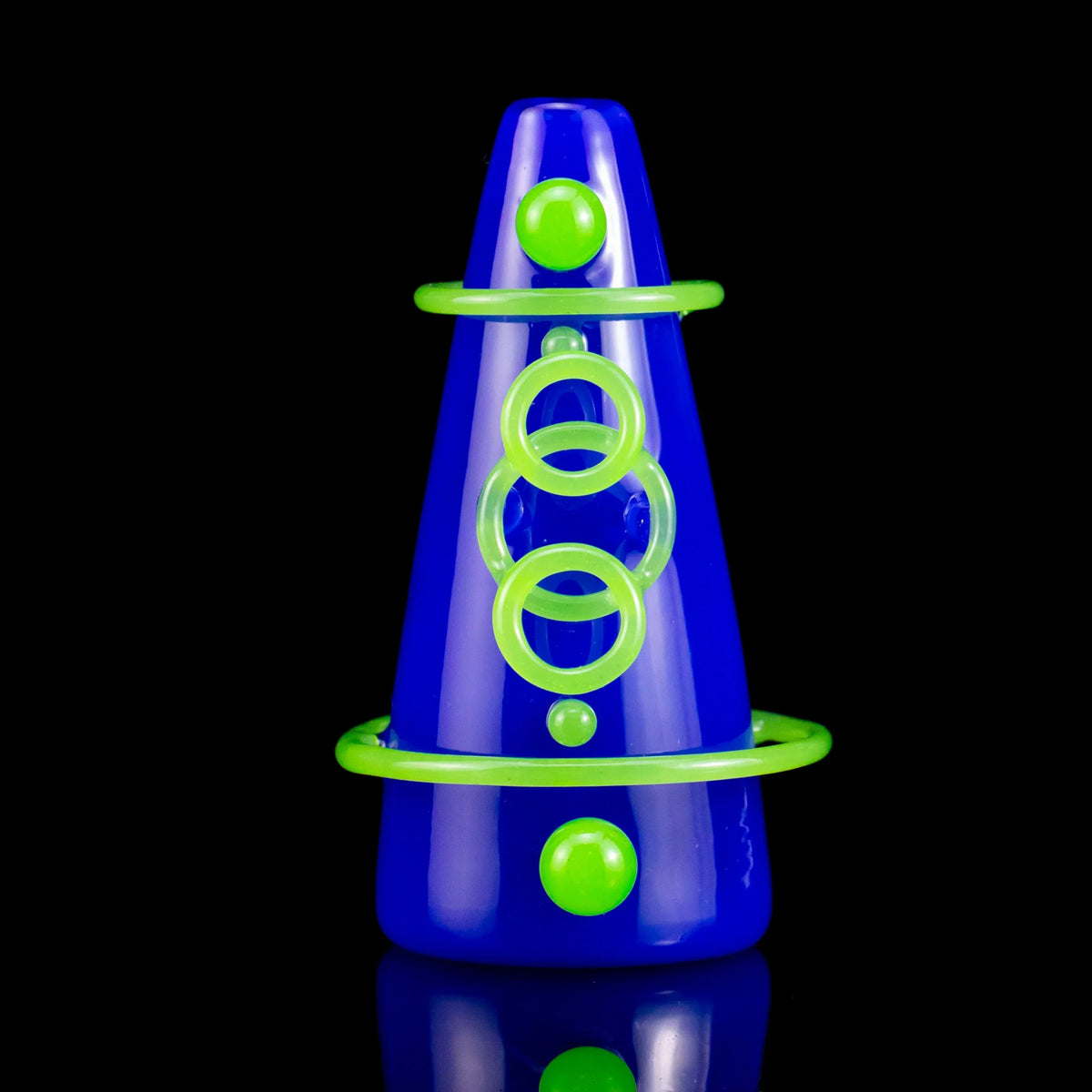 Blue volcano-shaped glass pipe with neon green decorative rings and dots, on black background.