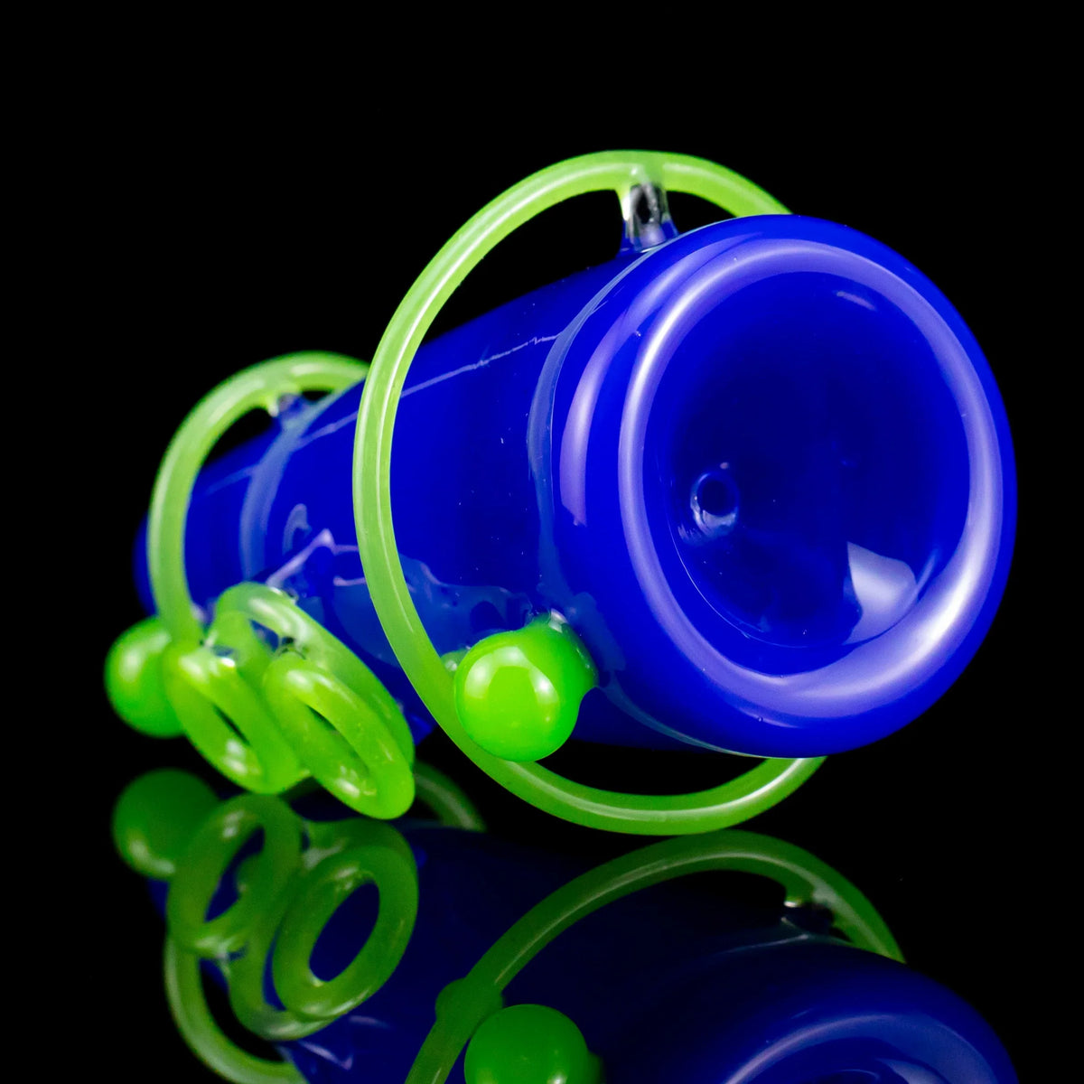blue glass hand pipe with neon green decorative rings on black background