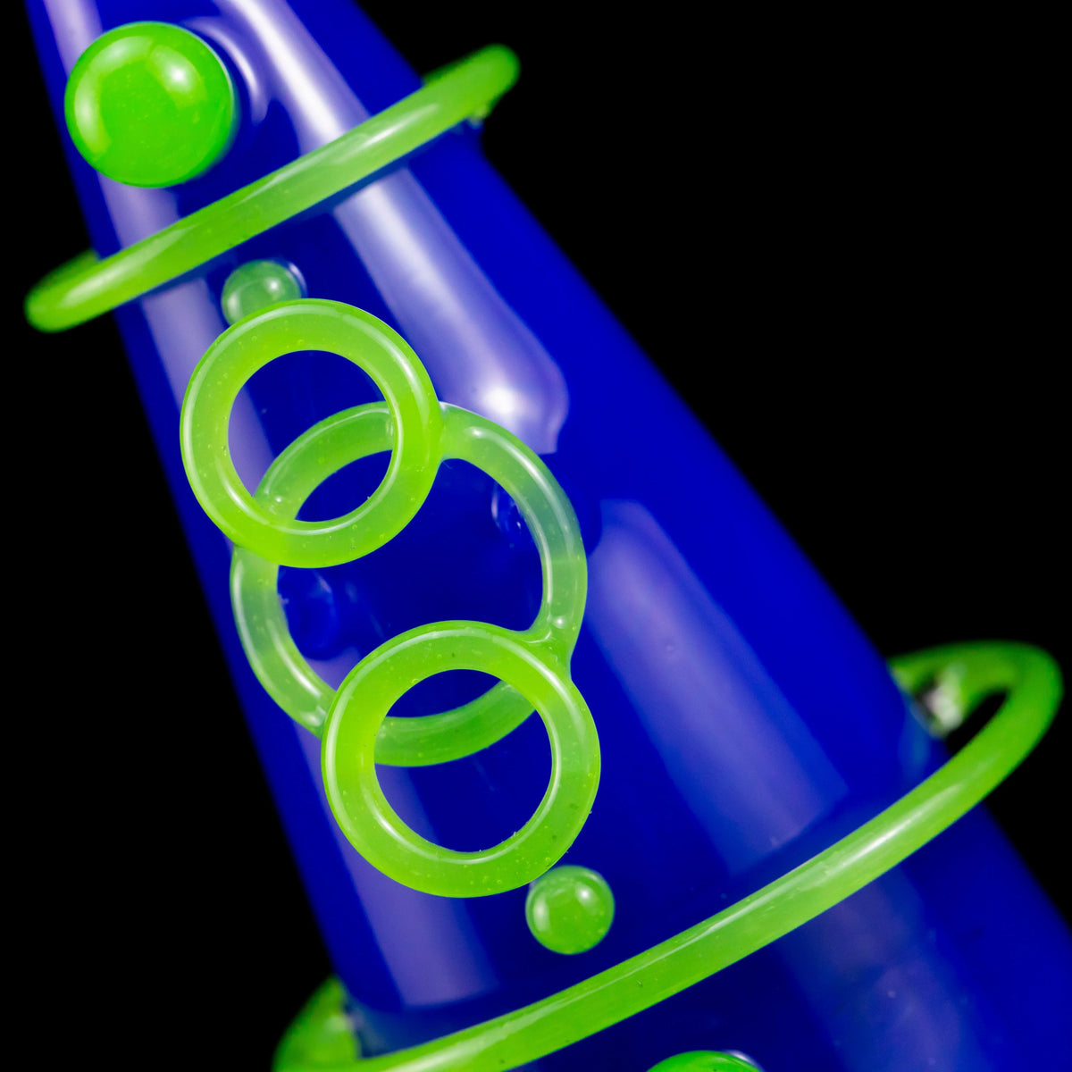 Blue glass pipe with neon green rings and decorative accents, close-up view