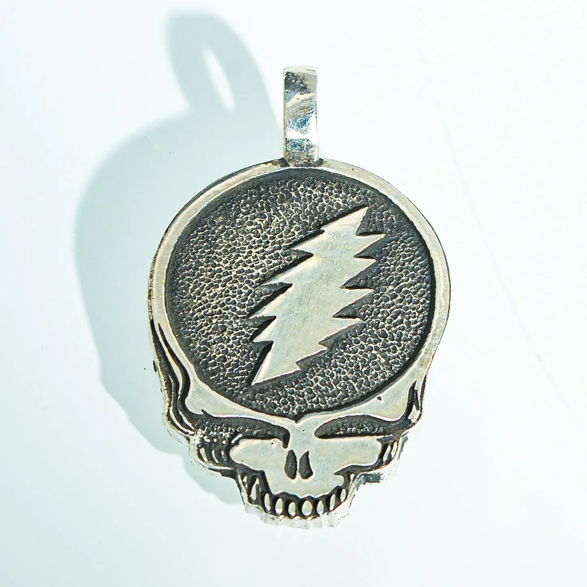 Sterling silver skull pendant with lightning bolt design, textured finish, jewelry accessory