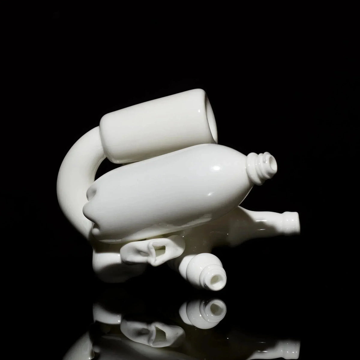Abstract white blown glass art pipe with sculpted ears and bottle shapes on a black background
