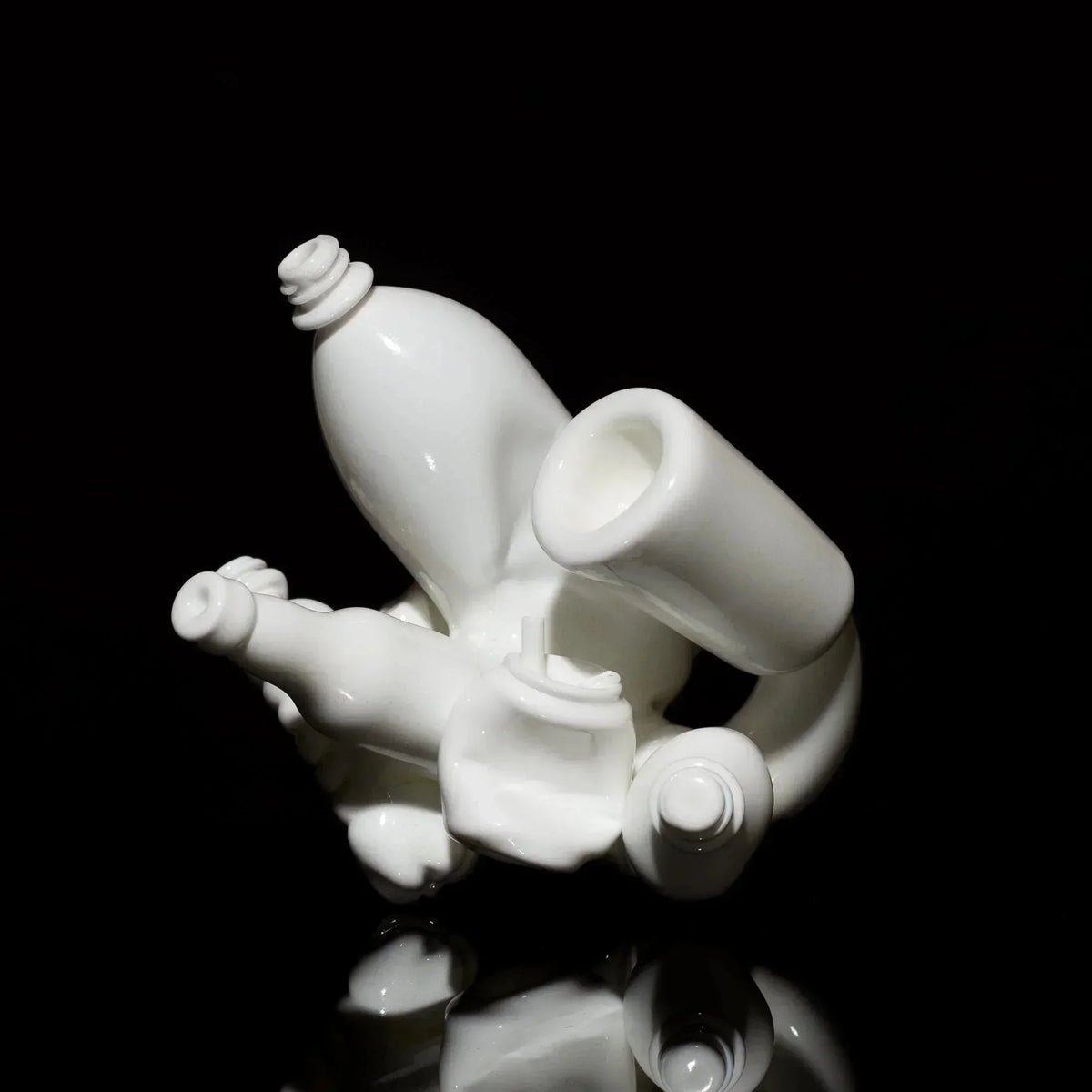 White heady glass art pipe with abstract sculptural design on black background
