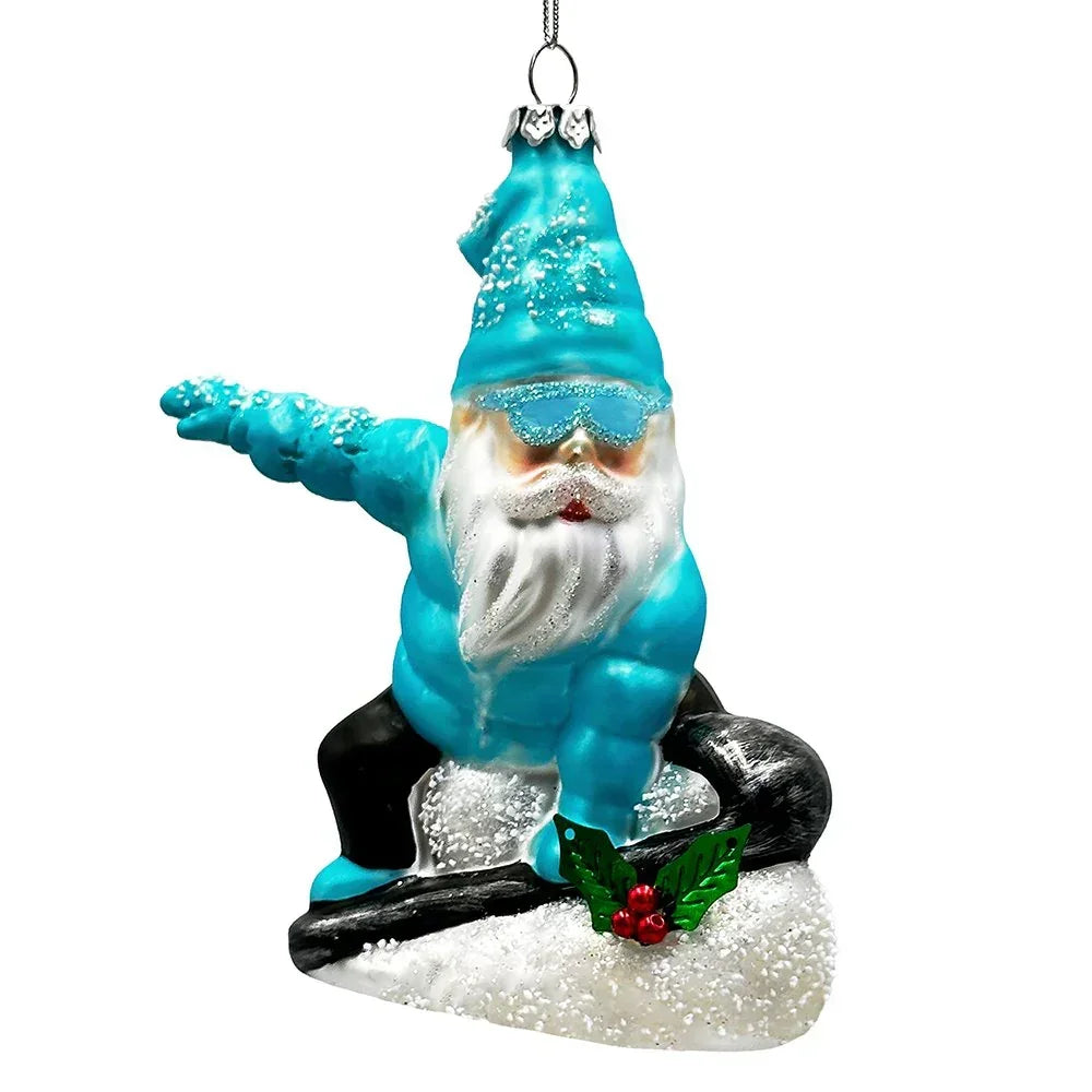 Glass ornament of a bearded gnome in blue snowboarding on a snowy hill with holly accents