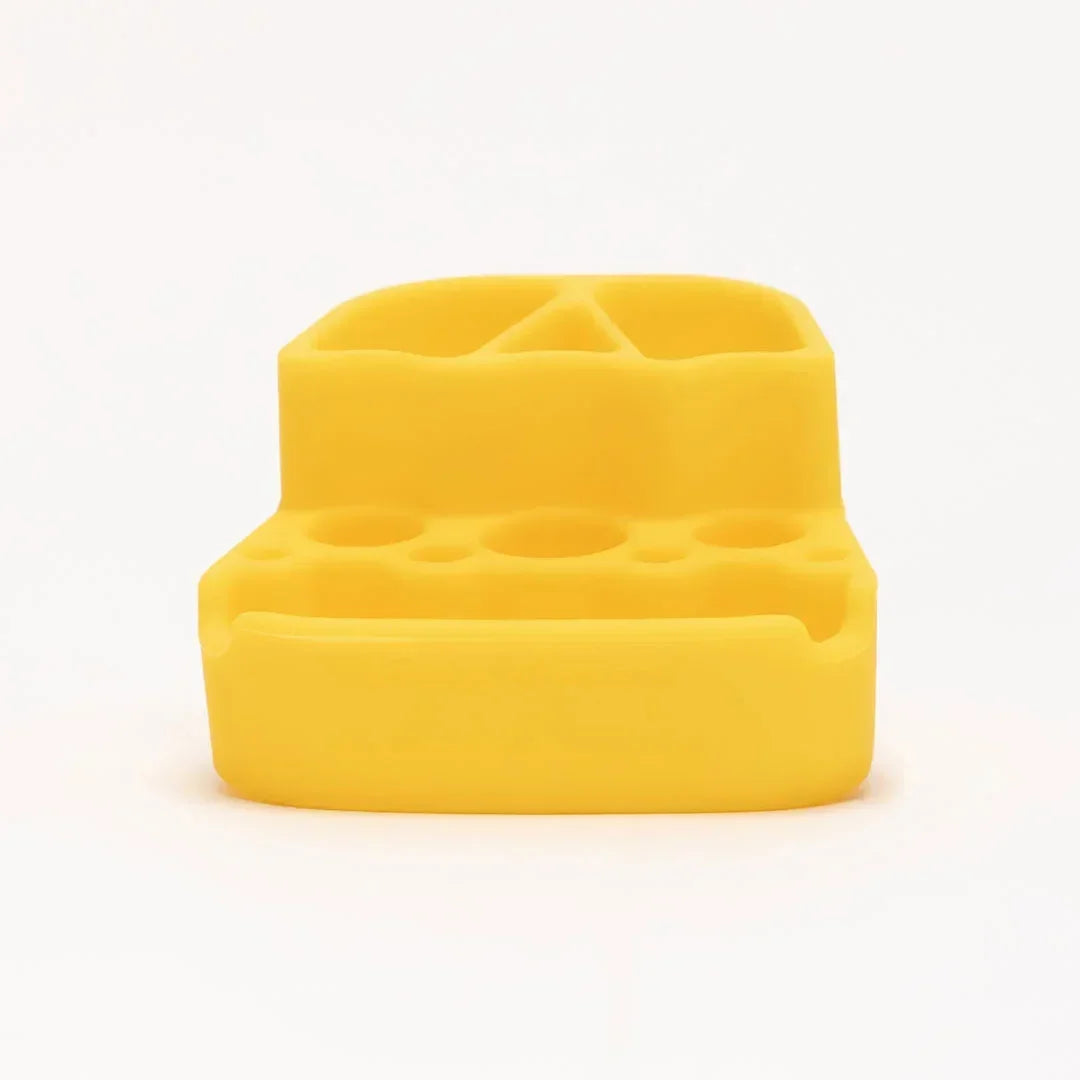 Yellow silicone organizer tray with multiple slots for glass accessories and tools.