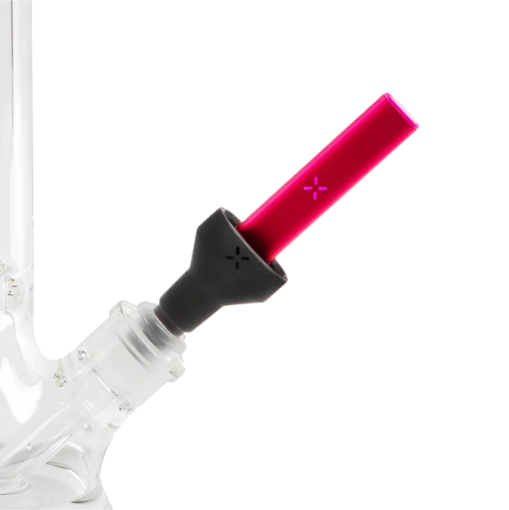 Red vaporizer accessory inserted into a clear glass water pipe on black background