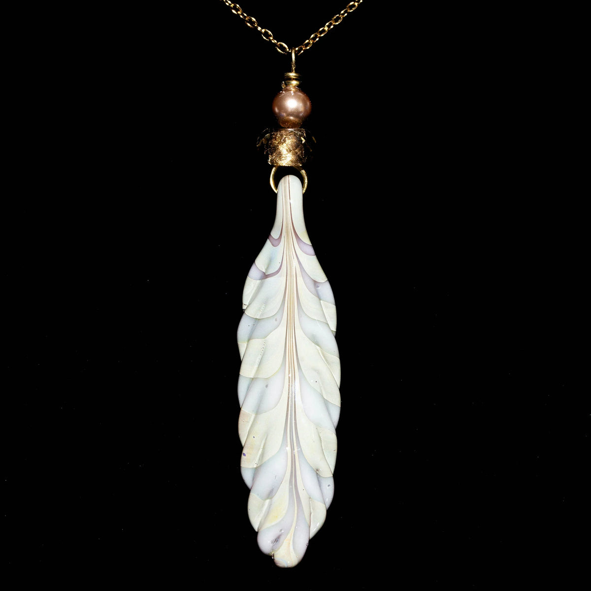 Hand-blown glass feather pendant with gold chain and bead, jewelry on black background