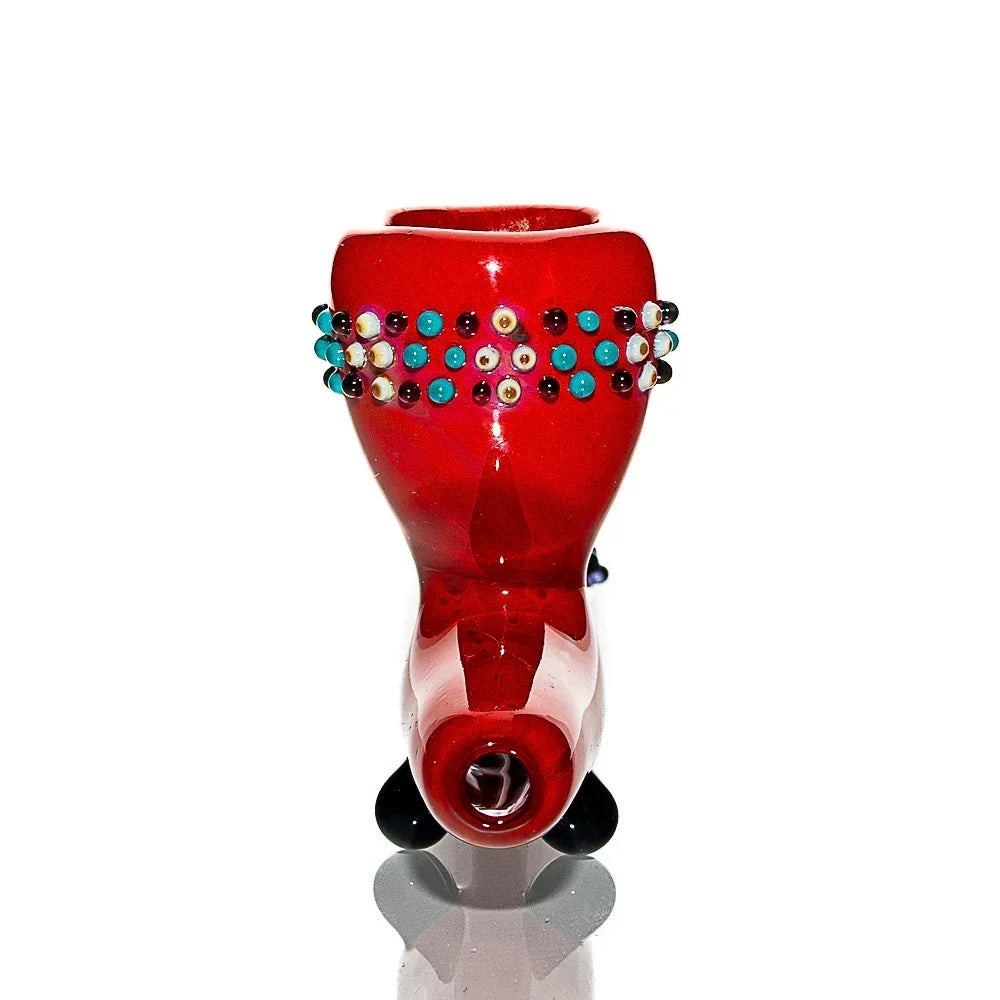 Red glass hand pipe with colorful dot accents, artistic smoking accessory on white background