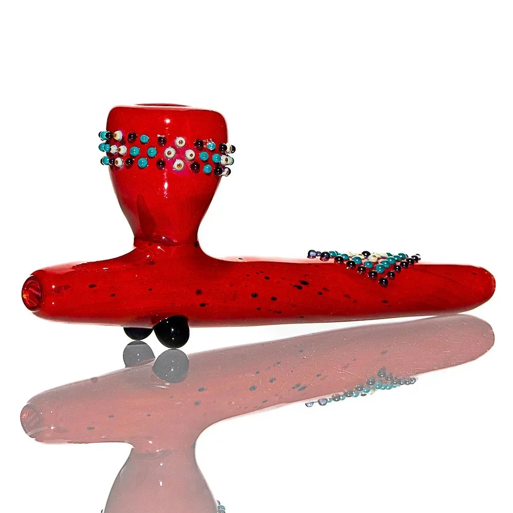 Red glass hand pipe with decorative turquoise and white bead accents, displayed on white background
