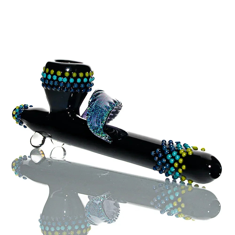 Handcrafted black glass smoking pipe with blue, green, and yellow decorative accents.
