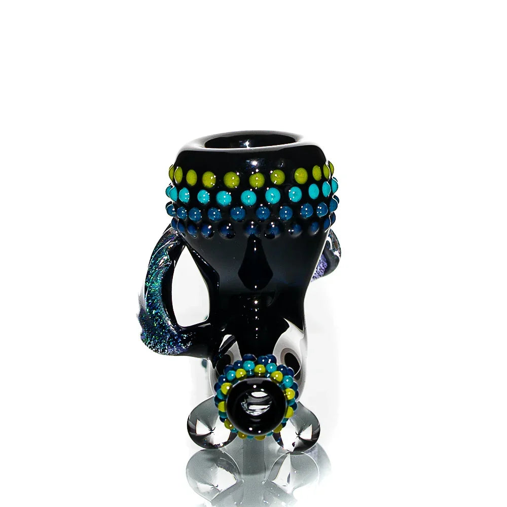 Handcrafted glass pipe with blue and green decorative dots and a reflective finish