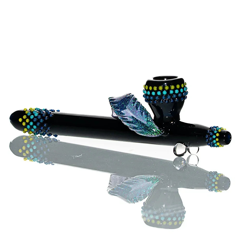 Handcrafted black glass ceremonial pipe with blue and yellow dot accents and a decorative feather