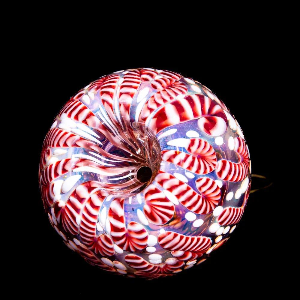 Hand-blown glass pipe with red and white candy cane swirl pattern on black background