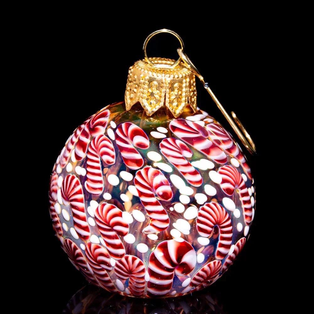 Hand-blown glass ornament pipe with red and white candy cane pattern, gold top detail.