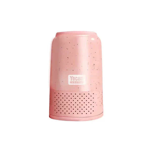 Pink Yocan desktop air purifier with vented base and speckled design on white background