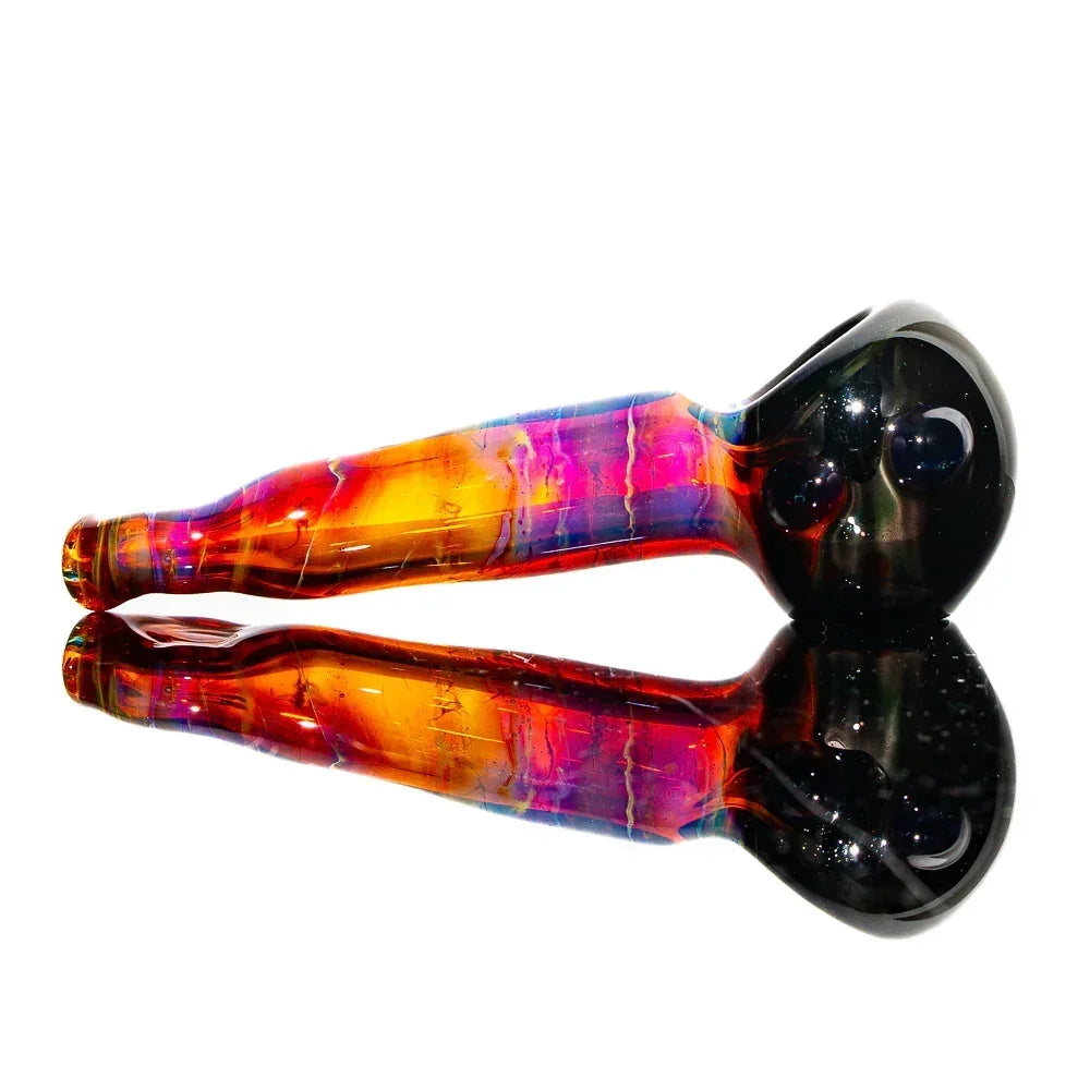 Amber purple glass hand pipe with vibrant colors and reflective surface