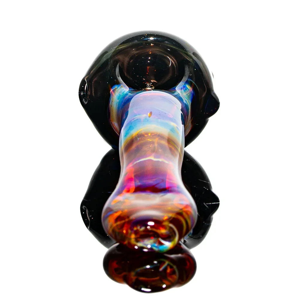 Handcrafted amber and purple glass spoon pipe with vibrant, swirling colors on white background