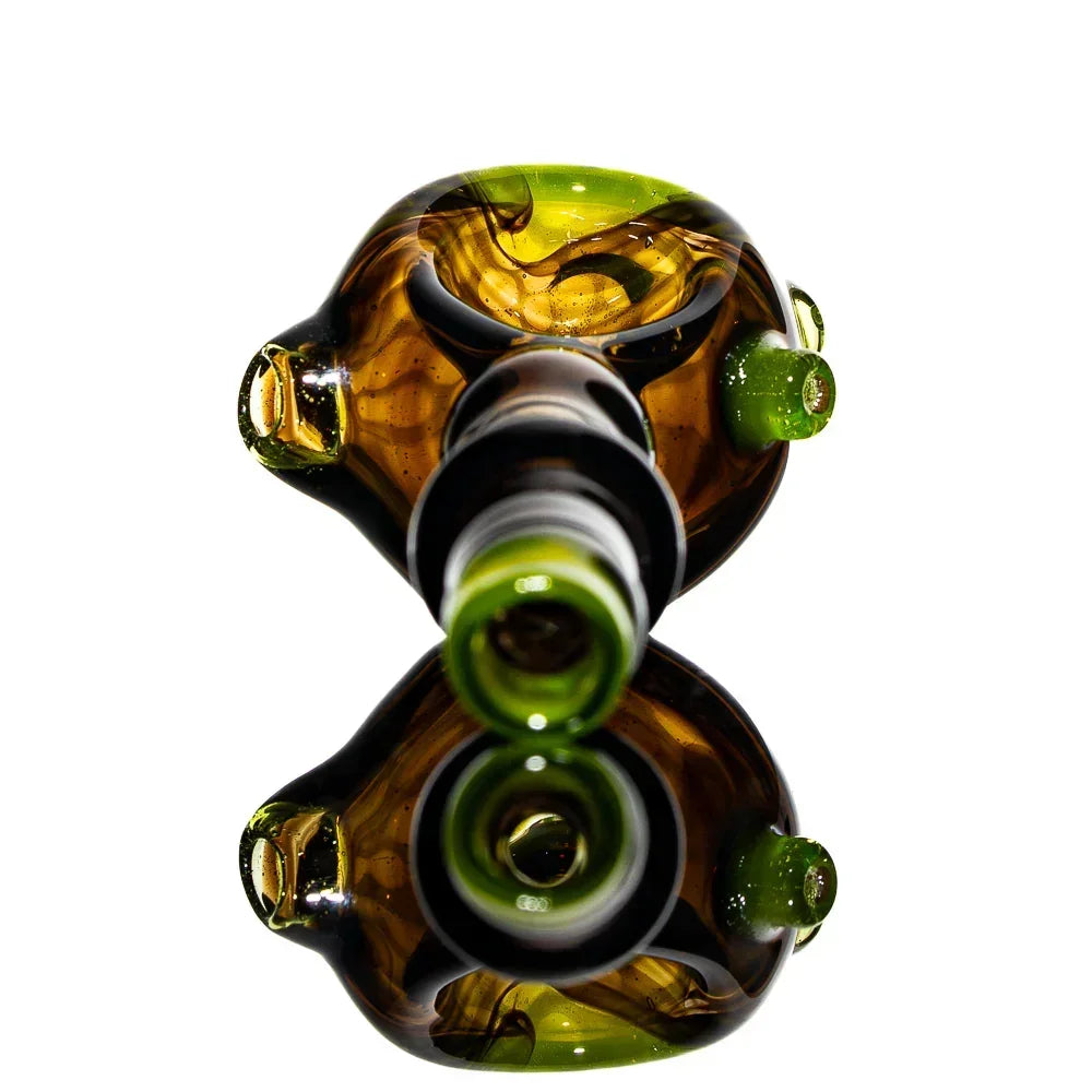 Black honeycomb glass spoon pipe with green accents on white background