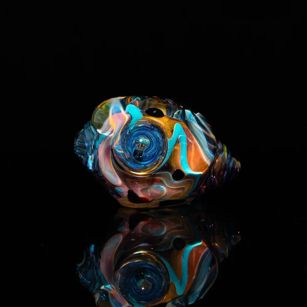 Colorful fumed glass art spoon pipe with inside-out swirls on black background
