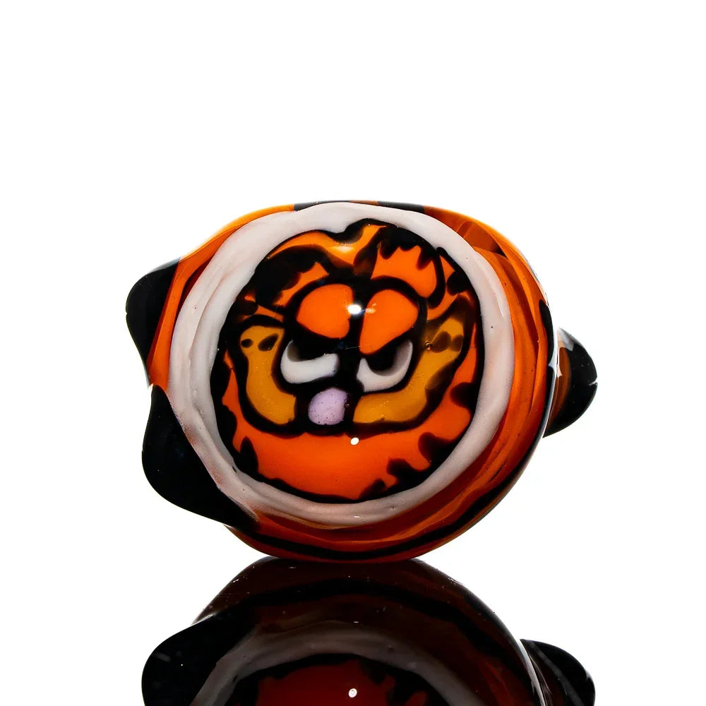 Hand-blown glass spoon pipe with orange cartoon cat face design, reflective black base